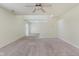 Open-concept living room featuring neutral carpet and a staircase, offering a versatile space at 565 Cembra Dr, Greenwood, IN 46143