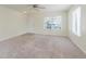 Bright living room with neutral carpet, a large window, and a welcoming entrance at 565 Cembra Dr, Greenwood, IN 46143