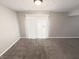 Bright living room with neutral carpet and sliding glass door at 5826 Buck Rill Dr, Indianapolis, IN 46237