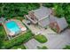 Stunning aerial view of a brick home with a pool, patio, and lush greenery at 6220 E 56Th St, Indianapolis, IN 46226