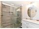 Modern bathroom with a glass-enclosed shower, stylish tile work, and a sleek vanity with elegant fixtures at 6220 E 56Th St, Indianapolis, IN 46226