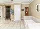 A stylish bathroom features a soaking tub, a shower, and a sauna door at 6220 E 56Th St, Indianapolis, IN 46226