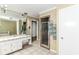 The bathroom has a shower, a vanity with cabinet space and a mirror above at 6220 E 56Th St, Indianapolis, IN 46226