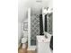Stylish bathroom featuring colorful shower with black curtain, modern fixtures, and unique tile flooring at 6220 E 56Th St, Indianapolis, IN 46226
