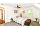 Warm and inviting bedroom featuring a stylish accent chair, ample natural light, and a cozy ottoman at 6220 E 56Th St, Indianapolis, IN 46226