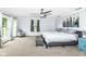 Spacious primary bedroom featuring a ceiling fan, ensuite bath, and access to a private deck at 6220 E 56Th St, Indianapolis, IN 46226