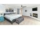 This primary bedroom boasts a large fireplace, a TV, and a gray upholstered storage bench at 6220 E 56Th St, Indianapolis, IN 46226