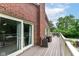 Exterior deck with chairs showcases the house's brickwork, sliding door access and views of the yard at 6220 E 56Th St, Indianapolis, IN 46226