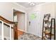 Inviting foyer featuring tile flooring, staircase, and decorative accents at 6220 E 56Th St, Indianapolis, IN 46226