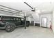 Spacious two car garage featuring epoxy flooring, storage cabinets and a modern black SUV at 6220 E 56Th St, Indianapolis, IN 46226