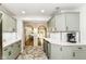 Renovated kitchen with stainless steel appliances, white countertops and light green cabinets at 6220 E 56Th St, Indianapolis, IN 46226