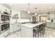 Spacious kitchen with stainless steel appliances, light green cabinets and a large kitchen island at 6220 E 56Th St, Indianapolis, IN 46226
