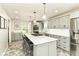 Large kitchen island with seating, stainless steel appliances, and light green cabinets at 6220 E 56Th St, Indianapolis, IN 46226