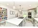 Bright kitchen with stainless appliances, central island, and a pantry with plenty of storage shelves at 6220 E 56Th St, Indianapolis, IN 46226