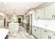 Spacious kitchen with stainless steel appliances, white countertops and light green cabinets at 6220 E 56Th St, Indianapolis, IN 46226