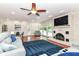 Bright living room with hardwood floors, fireplace, ceiling fan, light gray sofas and a blue rug at 6220 E 56Th St, Indianapolis, IN 46226