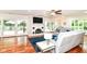 Bright living room with hardwood floors, brick fireplace, ceiling fan and sliding glass doors to the exterior at 6220 E 56Th St, Indianapolis, IN 46226
