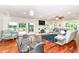Open living room with a fireplace, hardwood floors, and sliding doors to the patio at 6220 E 56Th St, Indianapolis, IN 46226
