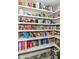 Walk-in pantry features well-stocked shelves with food and household items for convenient storage at 6220 E 56Th St, Indianapolis, IN 46226