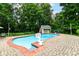 Inviting backyard pool surrounded by a brick patio with lounge chairs and well-manicured landscaping at 6220 E 56Th St, Indianapolis, IN 46226
