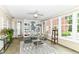 Bright sunroom with geometric rug, white shelving and many windows at 6220 E 56Th St, Indianapolis, IN 46226