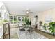 Bright sunroom with geometric rug, tile floors and many windows at 6220 E 56Th St, Indianapolis, IN 46226