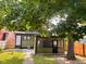 View of the backyard and house from under the shade of a large tree at 624 N Rural St, Indianapolis, IN 46201