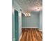 Finished basement featuring wood-look floors and light blue painted walls and trim at 624 N Rural St, Indianapolis, IN 46201