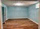 Spacious room in the basement features wood-look floors and light blue painted walls at 624 N Rural St, Indianapolis, IN 46201