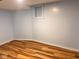 Finished basement area featuring wood flooring, painted walls, and a small window at 624 N Rural St, Indianapolis, IN 46201