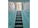 Painted basement stairs with metal railing leading up to a windowed door at 624 N Rural St, Indianapolis, IN 46201