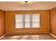 Bedroom with a large window, carpeting, and wood paneling at 624 N Rural St, Indianapolis, IN 46201
