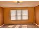 Cozy bedroom with three-window natural light and neutral carpeting at 624 N Rural St, Indianapolis, IN 46201