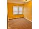 Cozy bedroom with neutral carpet, a window bringing in natural light, and freshly painted walls at 624 N Rural St, Indianapolis, IN 46201