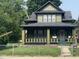 Charming two-story home featuring a covered front porch and a well-maintained yard at 624 N Rural St, Indianapolis, IN 46201