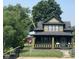 Charming two-story home featuring a covered front porch and a well-maintained yard at 624 N Rural St, Indianapolis, IN 46201
