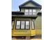 A close up of an olive-green house with black trim and white windows at 624 N Rural St, Indianapolis, IN 46201