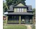 Charming two-story home featuring a covered front porch and a well-maintained yard at 624 N Rural St, Indianapolis, IN 46201