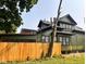 Side view of two-story home featuring new wooden fence at 624 N Rural St, Indianapolis, IN 46201