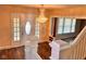 Inviting foyer with decorative glass front door, stunning chandelier, and hardwood flooring at 624 N Rural St, Indianapolis, IN 46201