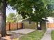 View of the back of the garage with gravel and fenced in area at 624 N Rural St, Indianapolis, IN 46201