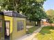 Backyard view of garages with gravel and fenced in area at 624 N Rural St, Indianapolis, IN 46201