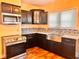 Kitchen features stainless steel appliances, custom cabinets, granite countertops, and tile backsplash at 624 N Rural St, Indianapolis, IN 46201