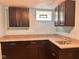 Basement kitchenette with dark cabinets, granite countertop and stainless-steel sink at 624 N Rural St, Indianapolis, IN 46201