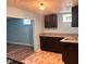 Basement kitchenette with granite countertops and dark wood cabinets, sink, and linoleum floor at 624 N Rural St, Indianapolis, IN 46201