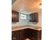 Basement kitchenette with granite countertops and dark wood cabinets at 624 N Rural St, Indianapolis, IN 46201