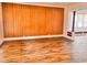 Spacious living room featuring wood floors and a wall with vintage wood panelling at 624 N Rural St, Indianapolis, IN 46201