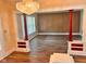 Open living room featuring a decorative chandelier, wood floors, and an open staircase at 624 N Rural St, Indianapolis, IN 46201