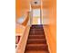 Carpeted staircase with white railings, leads to the second floor of the house at 624 N Rural St, Indianapolis, IN 46201
