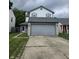 Two-story home featuring a gray two-car garage, gray roof, and gray and white siding at 6368 Titania Dr, Indianapolis, IN 46236